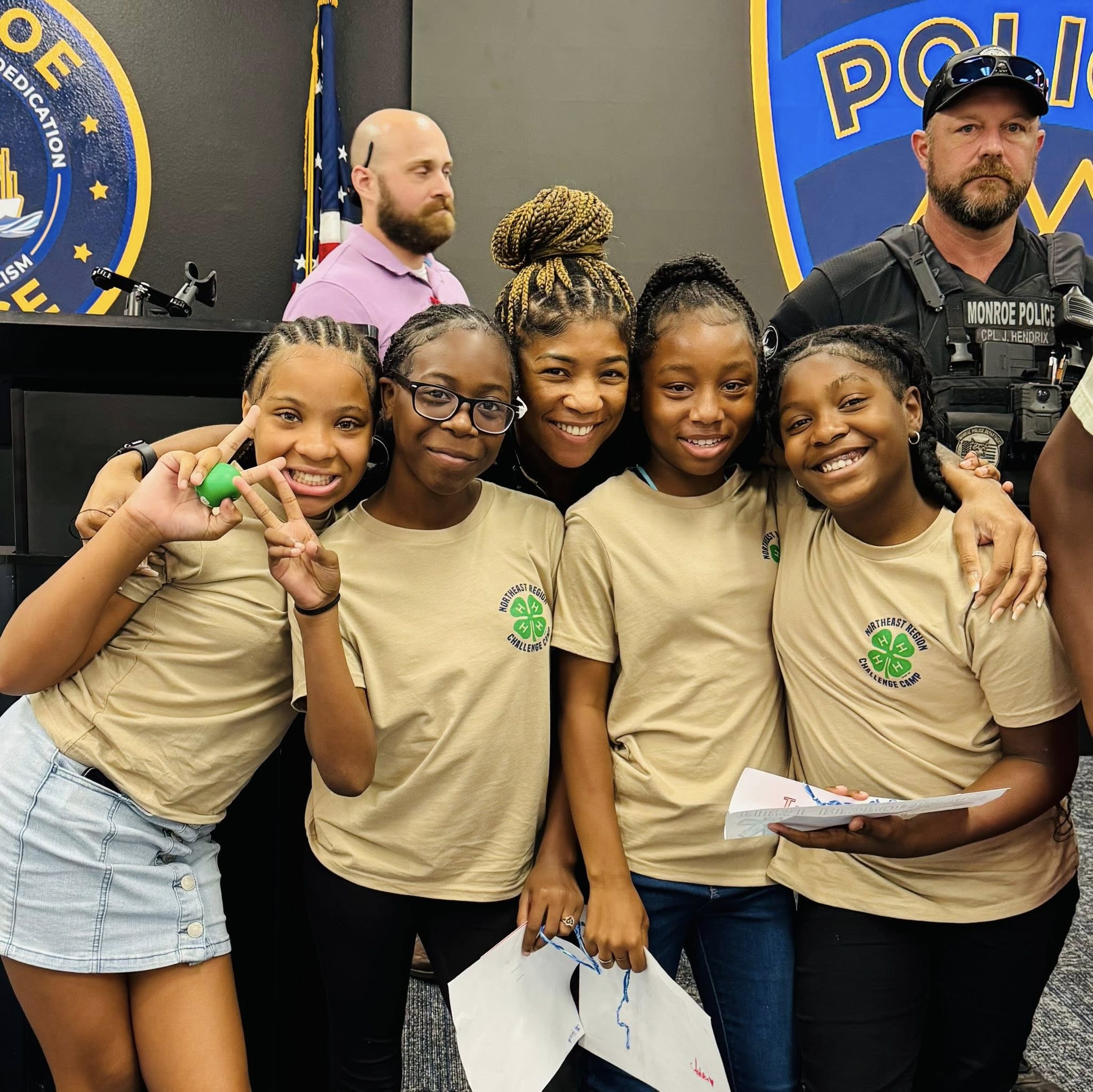 A woman posing for a picture with four girls.
